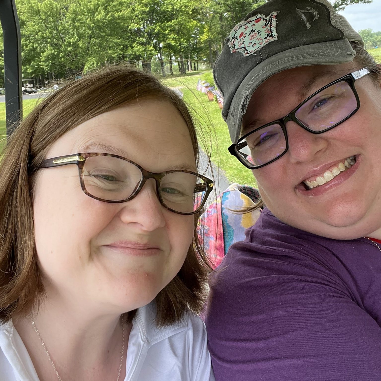 Melissa and Erika smiles at the camera during the 2022 Golf Outing
