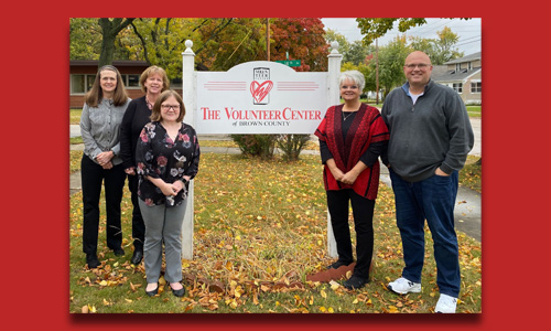 Five staff with the Volunteer Center signage